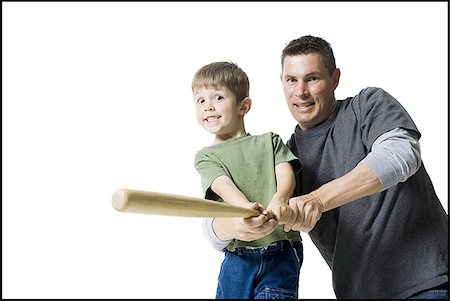 Portrait of a father teaching his son how to swing a baseball bat Stock Photo - Premium Royalty-Free, Code: 640-02765954