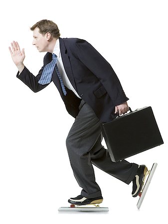 Profile of a businessman ice-skating and holding a briefcase Stock Photo - Premium Royalty-Free, Code: 640-02766080