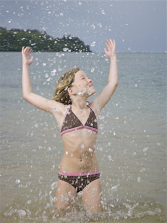 Close-up of a girl splashing water Stock Photo - Premium Royalty-Free, Code: 640-02766109