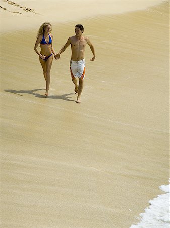 simsearch:640-02947668,k - High angle view of a young couple holding hands and running on the beach Stock Photo - Premium Royalty-Free, Code: 640-02766304