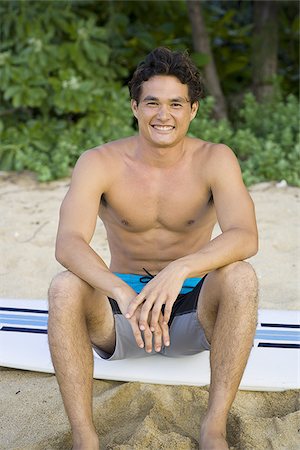 simsearch:640-01366190,k - Portrait of a young man sitting on a surfboard and smiling Stock Photo - Premium Royalty-Free, Code: 640-02766381