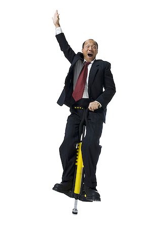 excited jumping suit - Portrait of a businessman on a pogo stick Stock Photo - Premium Royalty-Free, Code: 640-02766447
