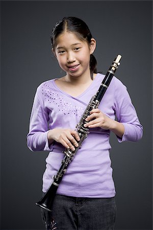 Portrait of a teenage girl holding a clarinet Stock Photo - Premium Royalty-Free, Code: 640-02766463