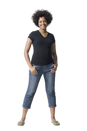 slippers women - Portrait of a young woman smiling with her hands in her pockets Stock Photo - Premium Royalty-Free, Code: 640-02766571