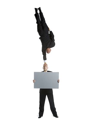 simsearch:640-02764552,k - Two male acrobats in business suits performing Foto de stock - Royalty Free Premium, Número: 640-02766654