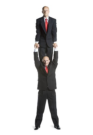 picture of a trapeze artist - Portrait of two male acrobats in business suits performing Stock Photo - Premium Royalty-Free, Code: 640-02766656