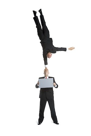 simsearch:640-02764552,k - Two male acrobats in business suits performing Foto de stock - Royalty Free Premium, Número: 640-02766653