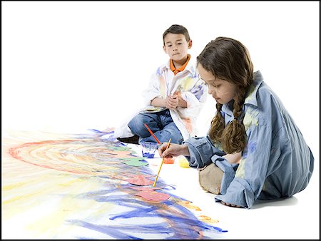 Girl and her brother painting on the floor Stock Photo - Premium Royalty-Free, Code: 640-02766804