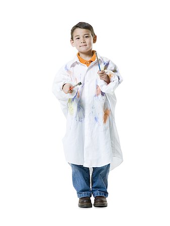 Portrait of a boy holding two paintbrushes Stock Photo - Premium Royalty-Free, Code: 640-02766810