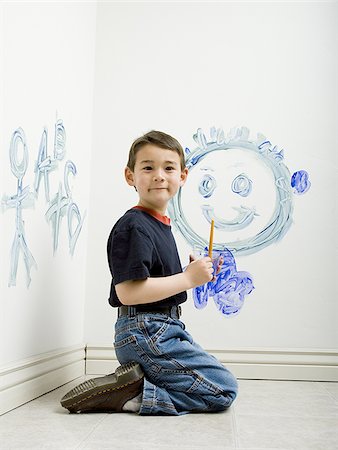 Portrait of a boy painting on a wall Stock Photo - Premium Royalty-Free, Code: 640-02766839