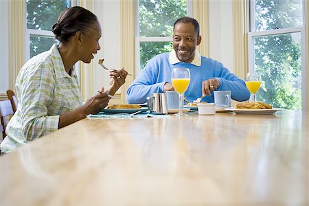 elderly black woman indoors - Senior man and a senior woman having breakfast Stock Photo - Premium Royalty-Free, Code: 640-02766892