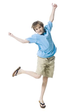Portrait of a boy jumping with joy Stock Photo - Premium Royalty-Free, Code: 640-02766987