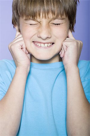 Close-up of a boy making a face Stock Photo - Premium Royalty-Free, Code: 640-02766981