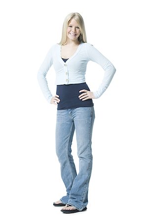 female jeans and slippers - Portrait of a young woman standing with her arms crossed Stock Photo - Premium Royalty-Free, Code: 640-02767014