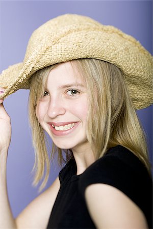 Portrait of a girl holding her hat Stock Photo - Premium Royalty-Free, Code: 640-02767027