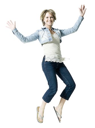 simsearch:649-06717622,k - Portrait of a young woman jumping in mid air Foto de stock - Royalty Free Premium, Número: 640-02767023