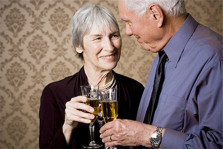 elegant 70 year old woman - Portrait of an elderly couple holding glasses of wine Stock Photo - Premium Royalty-Free, Code: 640-02767075