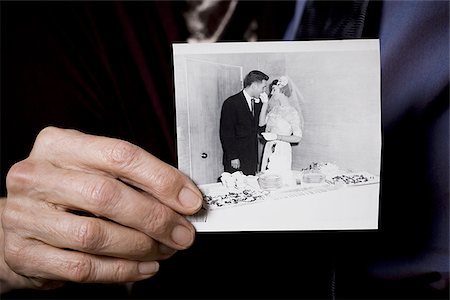 senior couple holding wedding photo - Portrait of an elderly couple showing a photograph Stock Photo - Premium Royalty-Free, Code: 640-02767070