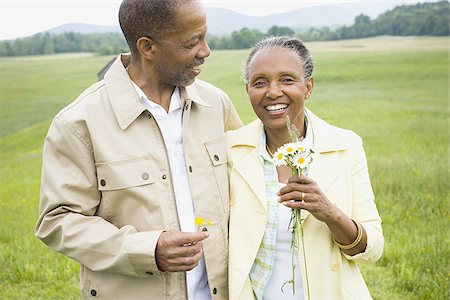 person walking field flowers - Portrait of a senior man and a senior woman smiling Stock Photo - Premium Royalty-Free, Code: 640-02767159