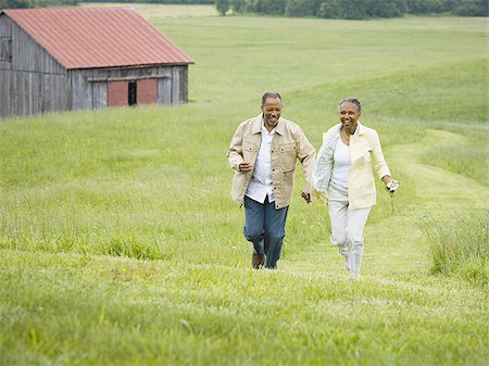 Senior woman and a senior man running in a field Stock Photo - Premium Royalty-Free, Code: 640-02767165