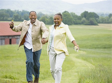 Senior woman and a senior man running in a field Stock Photo - Premium Royalty-Free, Code: 640-02767168
