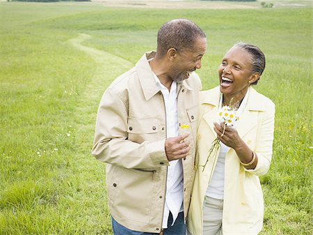 Close-up of a senior man and a senior woman smiling Stock Photo - Premium Royalty-Free, Code: 640-02767160