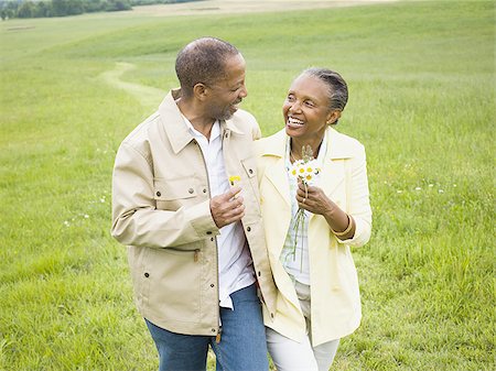 person walking field flowers - Close-up of a senior man and a senior woman smiling Stock Photo - Premium Royalty-Free, Code: 640-02767162