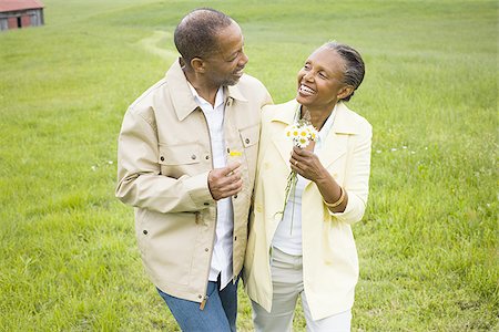 elder blossom - Close-up of a senior man and a senior woman smiling Stock Photo - Premium Royalty-Free, Code: 640-02767163