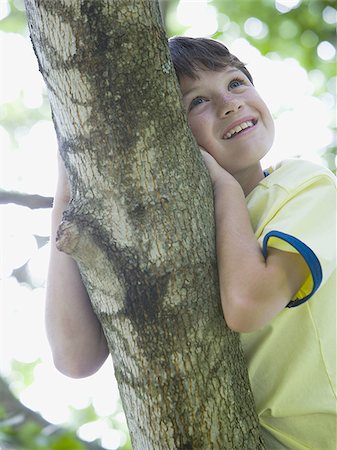 simsearch:400-06794010,k - Low angle view of a boy lying on the branch of a tree Stock Photo - Premium Royalty-Free, Code: 640-02767244