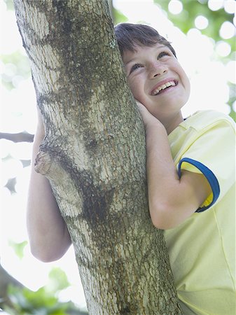simsearch:400-06794010,k - Low angle view of a boy lying on the branch of a tree Stock Photo - Premium Royalty-Free, Code: 640-02767245
