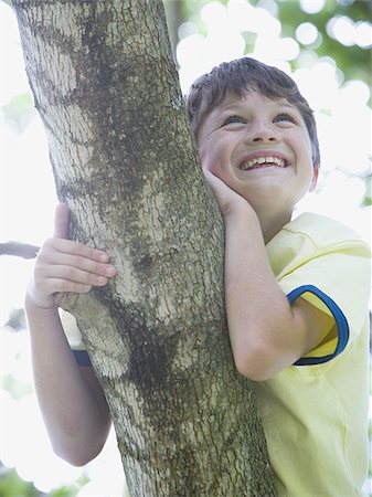 simsearch:400-06794010,k - Low angle view of a boy lying on the branch of a tree Stock Photo - Premium Royalty-Free, Code: 640-02767246