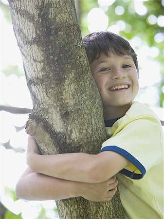 simsearch:400-06794010,k - Low angle view of a boy lying on the branch of a tree Stock Photo - Premium Royalty-Free, Code: 640-02767247