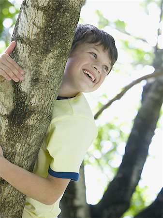 simsearch:400-06794010,k - Low angle view of a boy lying on the branch of a tree Stock Photo - Premium Royalty-Free, Code: 640-02767242