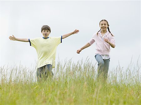fun kid 10 - Boy and a girl running in a field Stock Photo - Premium Royalty-Free, Code: 640-02767258