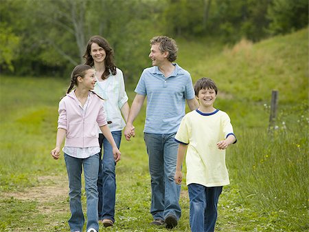 father son walking in field - woman and a man with their son and daughter Stock Photo - Premium Royalty-Free, Code: 640-02767250