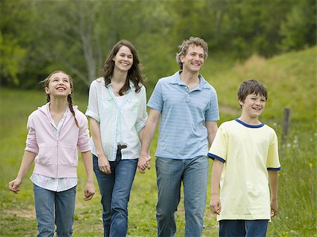 father son walking in field - woman and a man with their son and daughter Stock Photo - Premium Royalty-Free, Code: 640-02767251