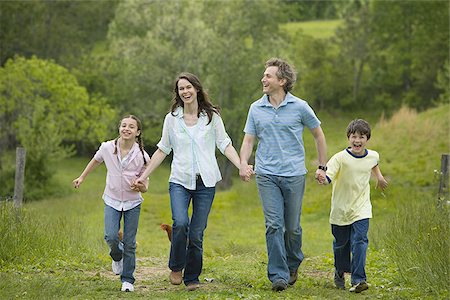 simsearch:640-02767193,k - woman and a man with their son and daughter running in a field Stock Photo - Premium Royalty-Free, Code: 640-02767252