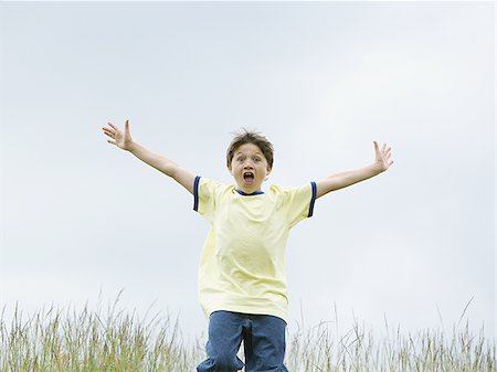 simsearch:400-06794010,k - Portrait of a boy running with his arms outstretched Stock Photo - Premium Royalty-Free, Code: 640-02767260