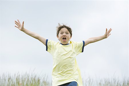 simsearch:400-06794010,k - Portrait of a boy running with his arms outstretched Stock Photo - Premium Royalty-Free, Code: 640-02767261