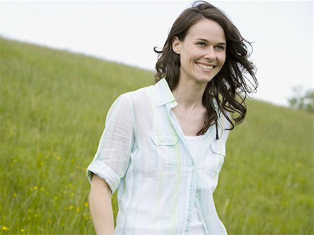 Low angle view of a woman laughing in a field Stock Photo - Premium Royalty-Free, Code: 640-02767270