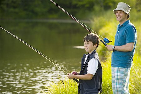 Profile of a man and his son fishing Stock Photo - Premium Royalty-Free, Code: 640-02767346