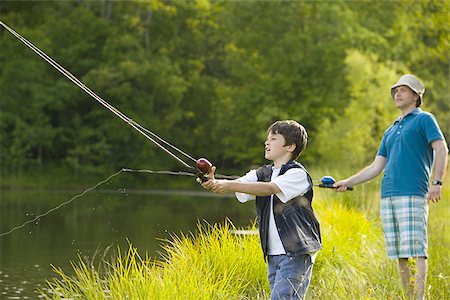 fishing fashion - Profile of a man and his son fishing Stock Photo - Premium Royalty-Free, Code: 640-02767348