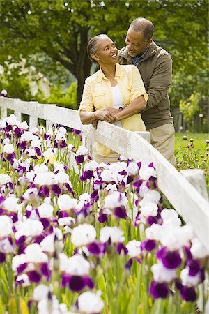 smiling elderly black man - Senior man and a senior woman standing near a fence Stock Photo - Premium Royalty-Free, Code: 640-02767456