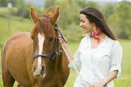 simsearch:640-02767509,k - Portrait of a woman holding the reins of a horse Foto de stock - Sin royalties Premium, Código: 640-02767468