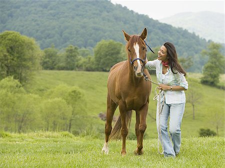 simsearch:640-02767509,k - woman holding the reins of a horse Foto de stock - Sin royalties Premium, Código: 640-02767478