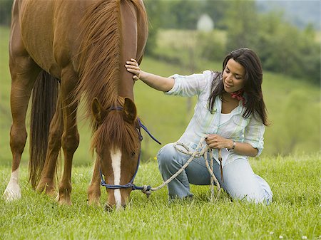 Portrait of a woman holding the reins of a horse Stock Photo - Premium Royalty-Free, Code: 640-02767479