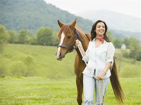 woman walking with a horse Stock Photo - Premium Royalty-Free, Code: 640-02767480