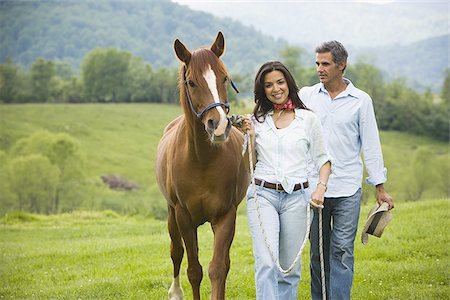 man and a woman walking with a horse Stock Photo - Premium Royalty-Free, Code: 640-02767494