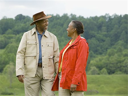 Senior man and a senior woman walking in a field Stock Photo - Premium Royalty-Free, Code: 640-02767525