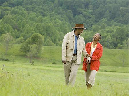 Senior man and a senior woman walking in a field Stock Photo - Premium Royalty-Free, Code: 640-02767528